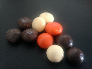 Illustration for article titled Hell Candy Face-Off: Pumpkin Spice Latte M&Ms Versus the Dreaded Dutch Ficorice
